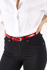 Model Charlotte wearing size XS of the Work It Belt in colour Red (Red), from the front, cropped image