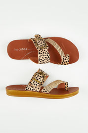 A model wearing size 37 of the Bria Flat Sandal in colour Cheetah, from the front, showing the whole outfit