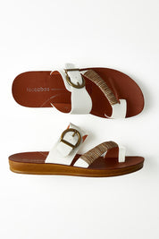 A model wearing size 37 of the Bria Flat Sandal in colour Offwhite (White), from the front, showing the whole outfit