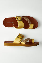A model wearing size 37 of the Bria Flat Sandal in colour Sunset, from the front, showing the whole outfit