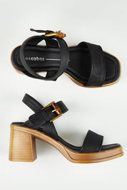 A model wearing size 37 of the Burgos Heel in colour Black (Black), from the front, showing the whole outfit
