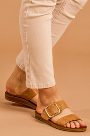 A model wearing size 38 of the Doti Double Strap Slide in colour Brandy, from the front, cropped image