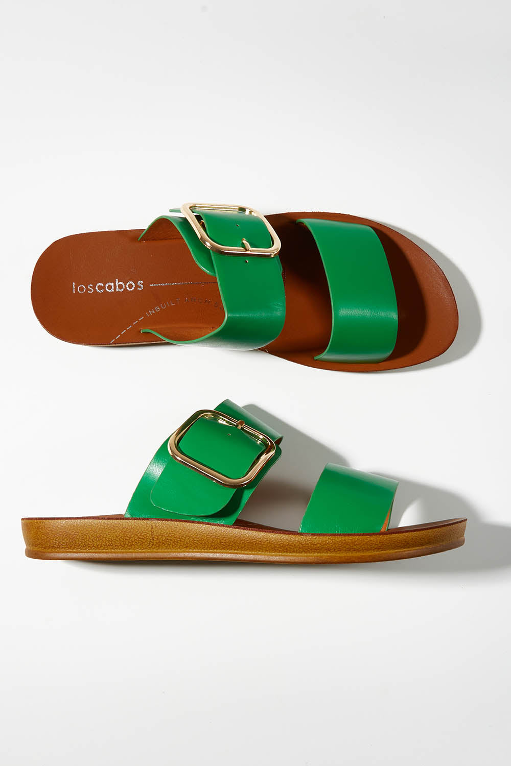 A model wearing size 37 of the Doti Double Strap Slide in colour Emerald (Green), from the front, showing the whole outfit