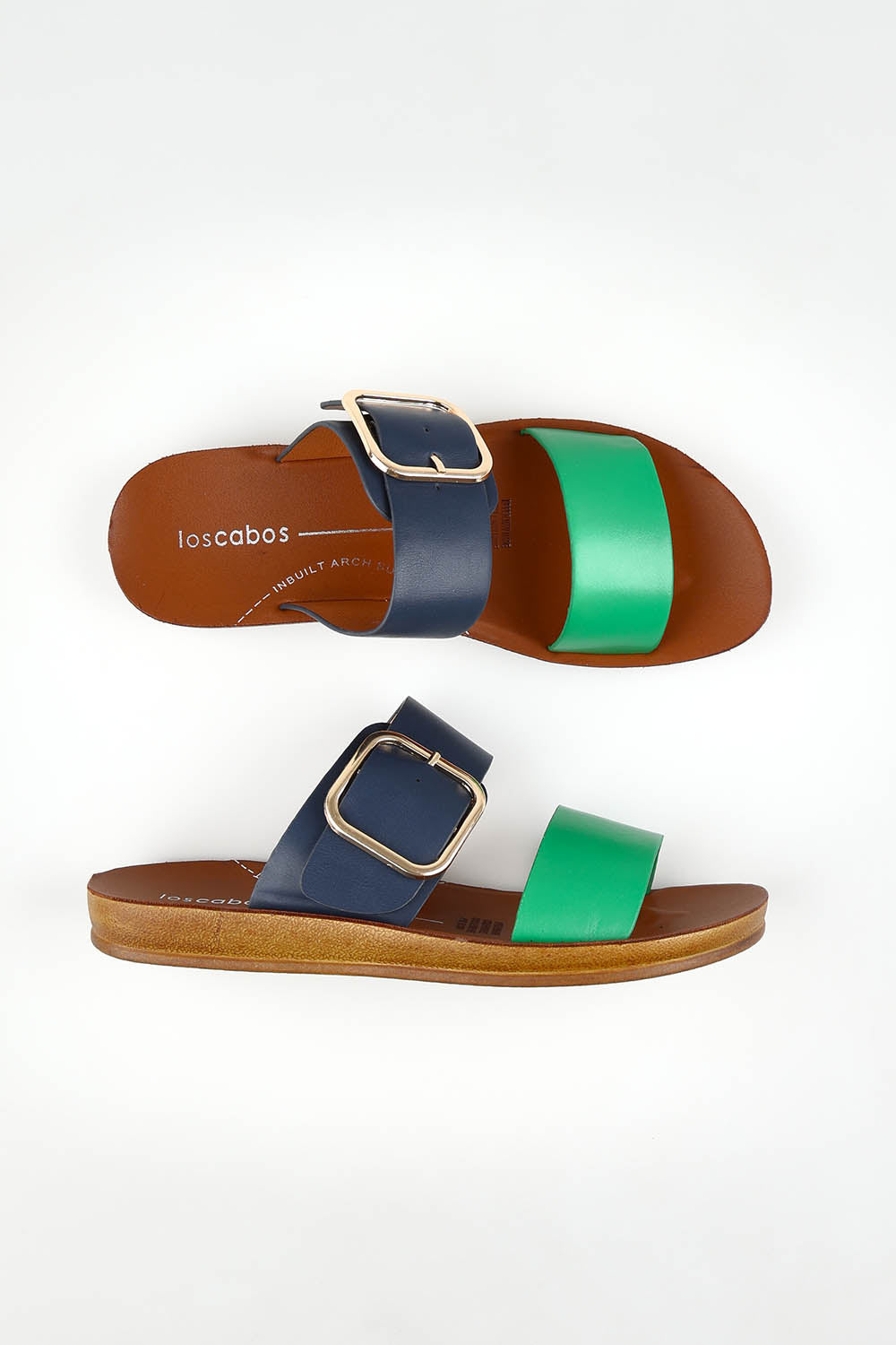 A model wearing size 37 of the Doti Double Strap Slide in colour Emeraldnav (Blue), from the front, showing the whole outfit