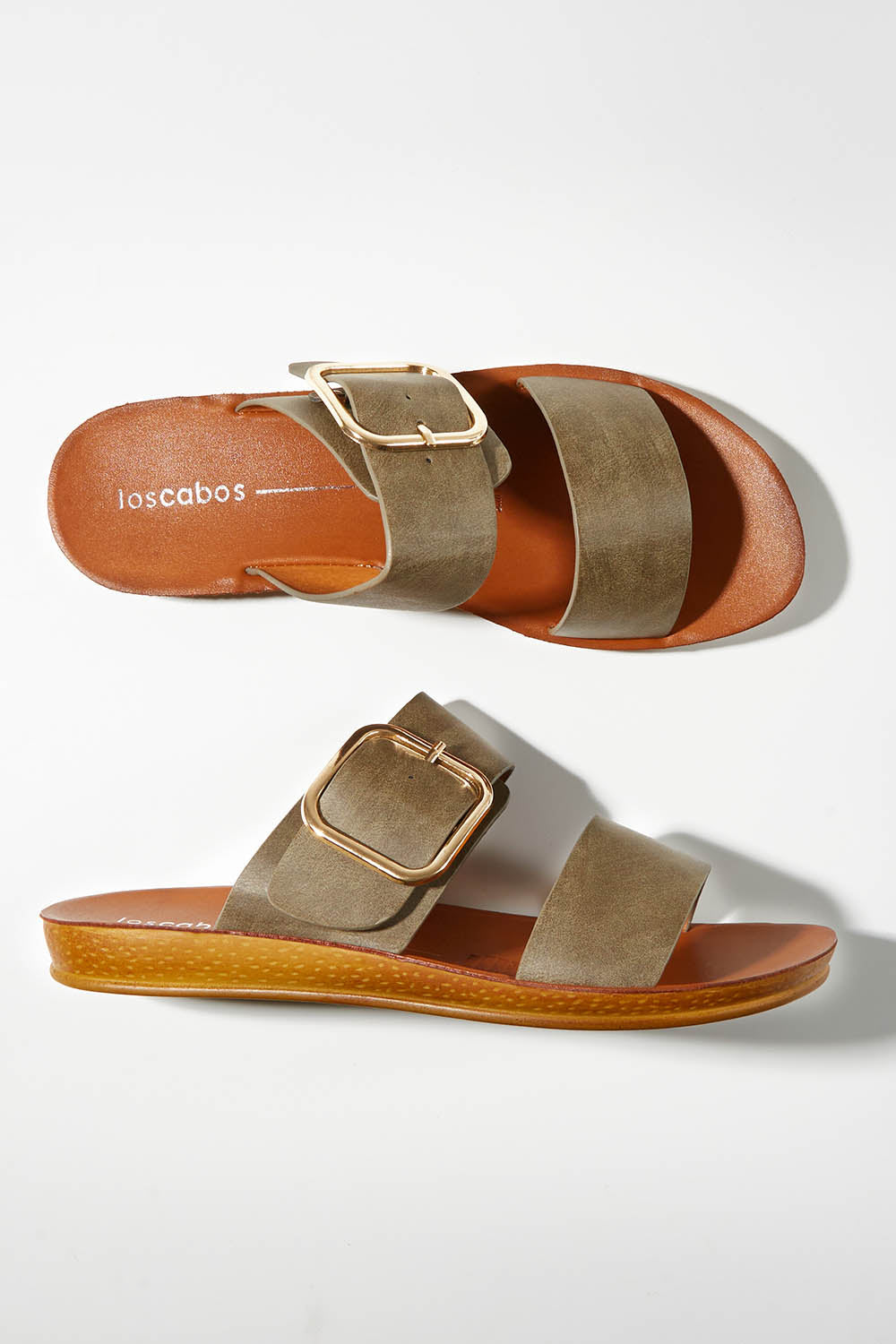 A model wearing size 37 of the Doti Double Strap Slide in colour Khaki (Green), from the front, showing the whole outfit