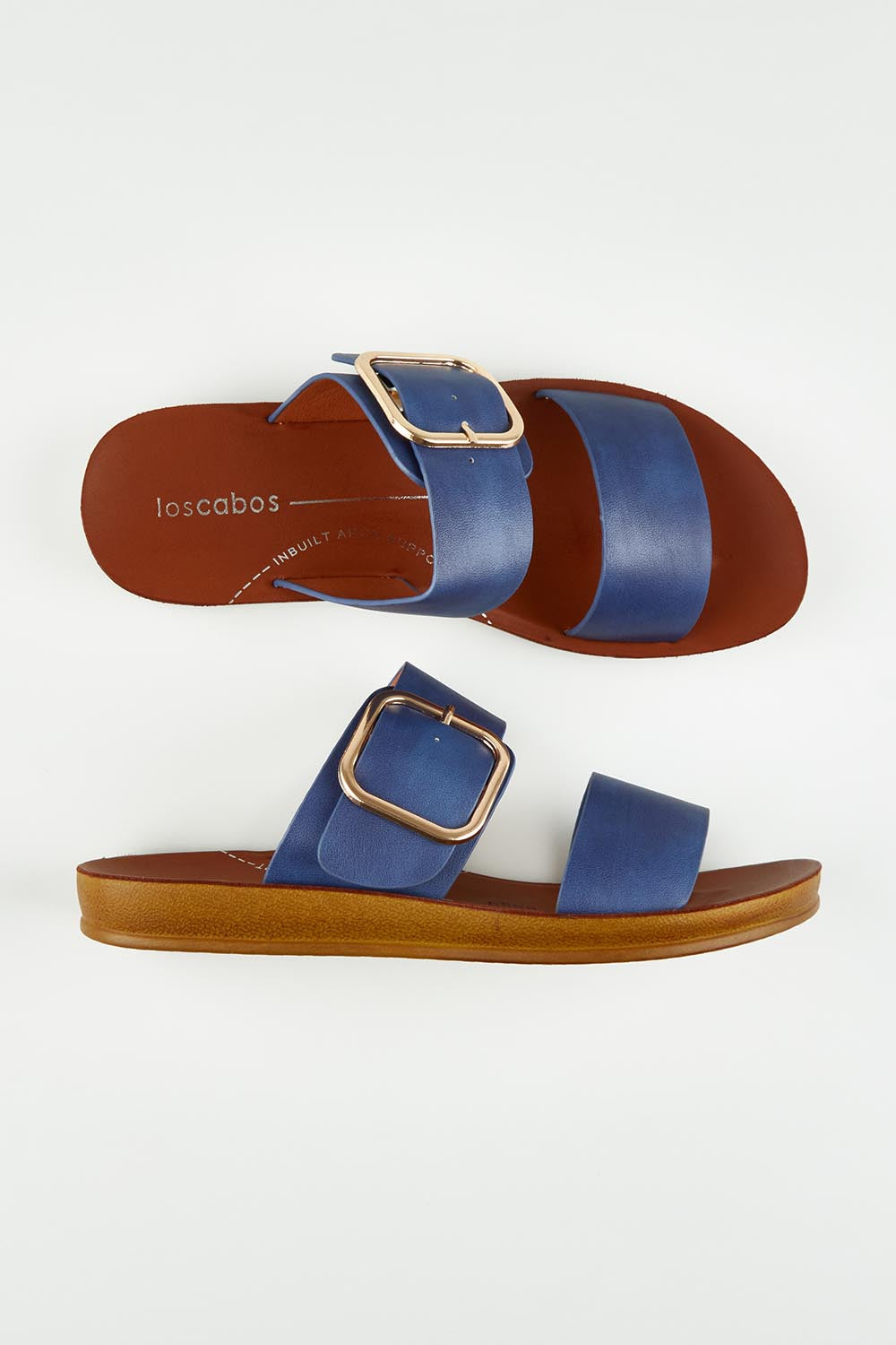 A model wearing size 37 of the Doti Double Strap Slide in colour Ocean (Blue), from the front, showing the whole outfit