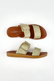 A model wearing size 37 of the Doti Double Strap Slide in colour Sage (Green), from the front, showing the whole outfit