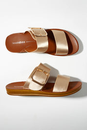 A model wearing size 37 of the Doti Double Strap Slide in colour Softgold (Metallics), from the front, showing the whole outfit