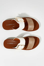 A model wearing size 37 of the Doti Double Strap Slide in colour Taupewhite (White), from the front, showing the whole outfit