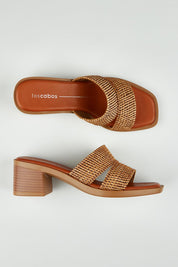 A model wearing size 37 of the Merida Slip On Heel in colour Chocolate, from the front, showing the whole outfit