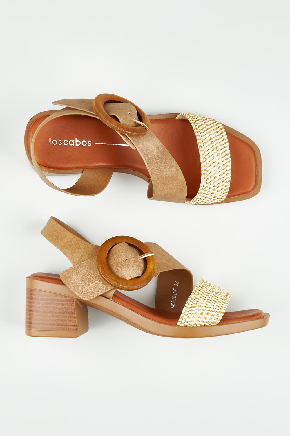 A model wearing size 37 of the Meridine Heel in colour Taupe, from the front, showing the whole outfit