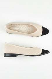 A model wearing size 37 of the Syracus Fly Knit Washable Flat in colour TaupeBlack, from the front, showing the whole outfit