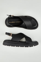 A model wearing size 37 of the Tolis Flatform Sandal in colour Black (Black), from the front, showing the whole outfit