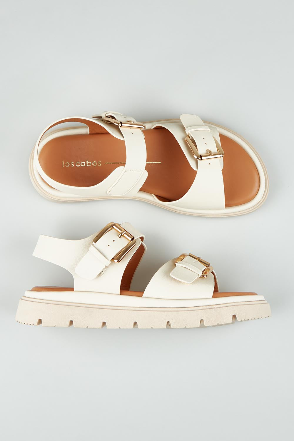 A model wearing size 37 of the Toli Flatform in colour Bone (White), from the front, showing the whole outfit