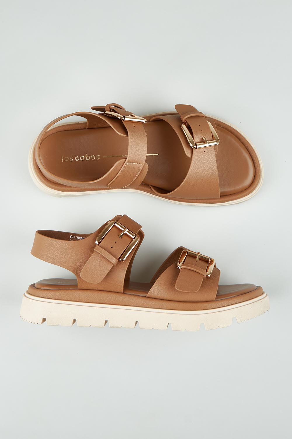 A model wearing size 37 of the Toli Flatform in colour Pecan, from the front, showing the whole outfit