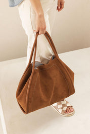 A model wearing the Sutton Shoulder Bag in colour Tansuede, from the front, showing the whole outfit