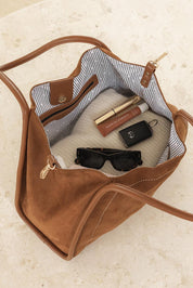 A model wearing the Sutton Shoulder Bag in colour Tansuede, from the front, showing the whole outfit