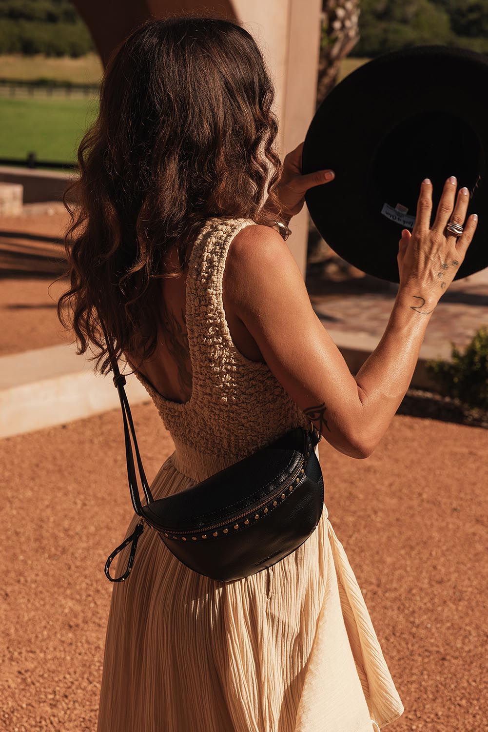 A model wearing the Cassidy Belt Bag in colour Black (Black), from the front, showing the whole outfit