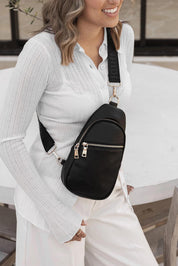 A model wearing the Bella Sling Bag in colour Black (Black), from the front, showing the whole outfit