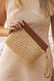 A model wearing the Fern Raffia Clutch Bag in colour Nattan, from the front, showing the whole outfit