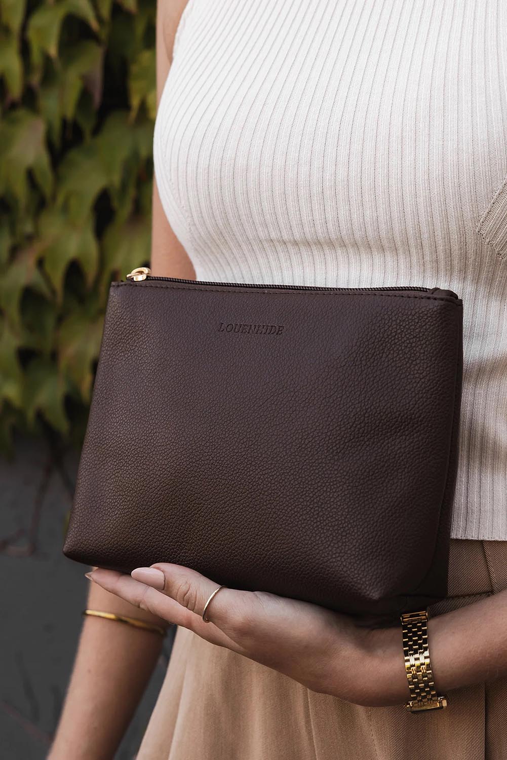 A model wearing The Everyday Pouch in colour Chocolate, from the front, showing the whole outfit