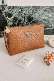 A model wearing the Carlo Pouch in colour Caramel, from the front, showing the whole outfit