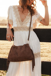 A model wearing the Reese Shoulder Bag in colour Chocolate, from the front, showing the whole outfit