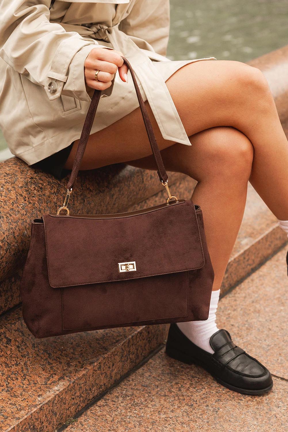 A model wearing the Arden Suedette Shoulder Bag in colour Chocolate, from the front, showing the whole outfit