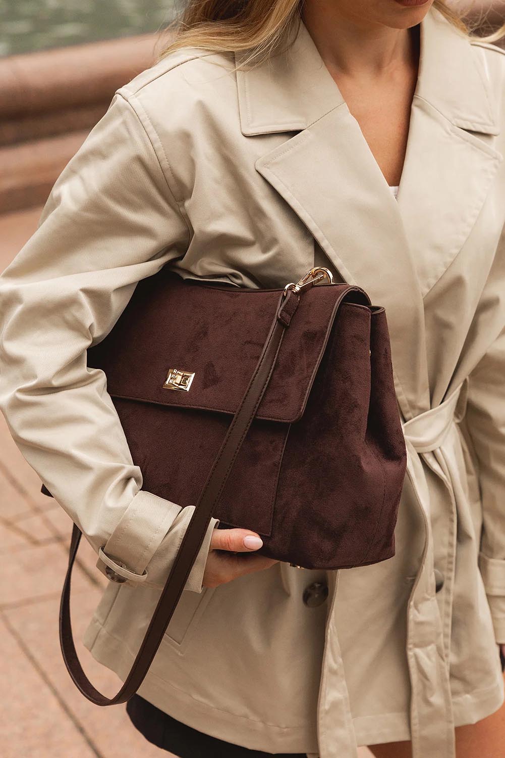 A model wearing the Arden Suedette Shoulder Bag in colour Chocolate, from the front, showing the whole outfit