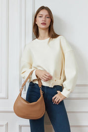 A model wearing the Georgina Shoulder Bag in colour Honey, from the front, showing the whole outfit