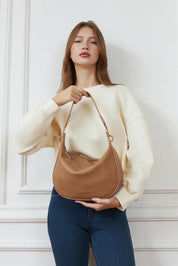 A model wearing the Georgina Shoulder Bag in colour Honey, from the front, showing the whole outfit