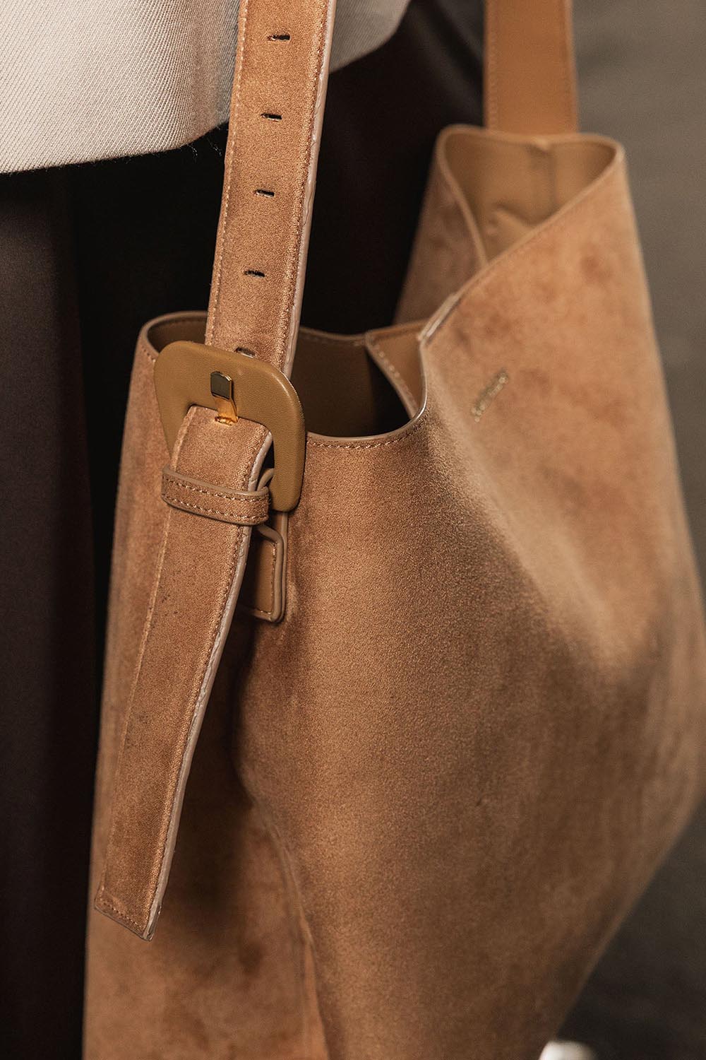 A model wearing the Peyton Suedette Shoulder Tote Bag in colour Honey, from the front, showing the whole outfit