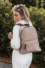 A model wearing the Carter Backpack in colour Mocha, from the front, showing the whole outfit
