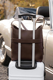 A model wearing the Audrey Shoulder Bag in colour Chocolate, from the front, showing the whole outfit