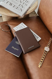 A model wearing the Venice Passport Wallet in colour Chocolate, from the front, showing the whole outfit