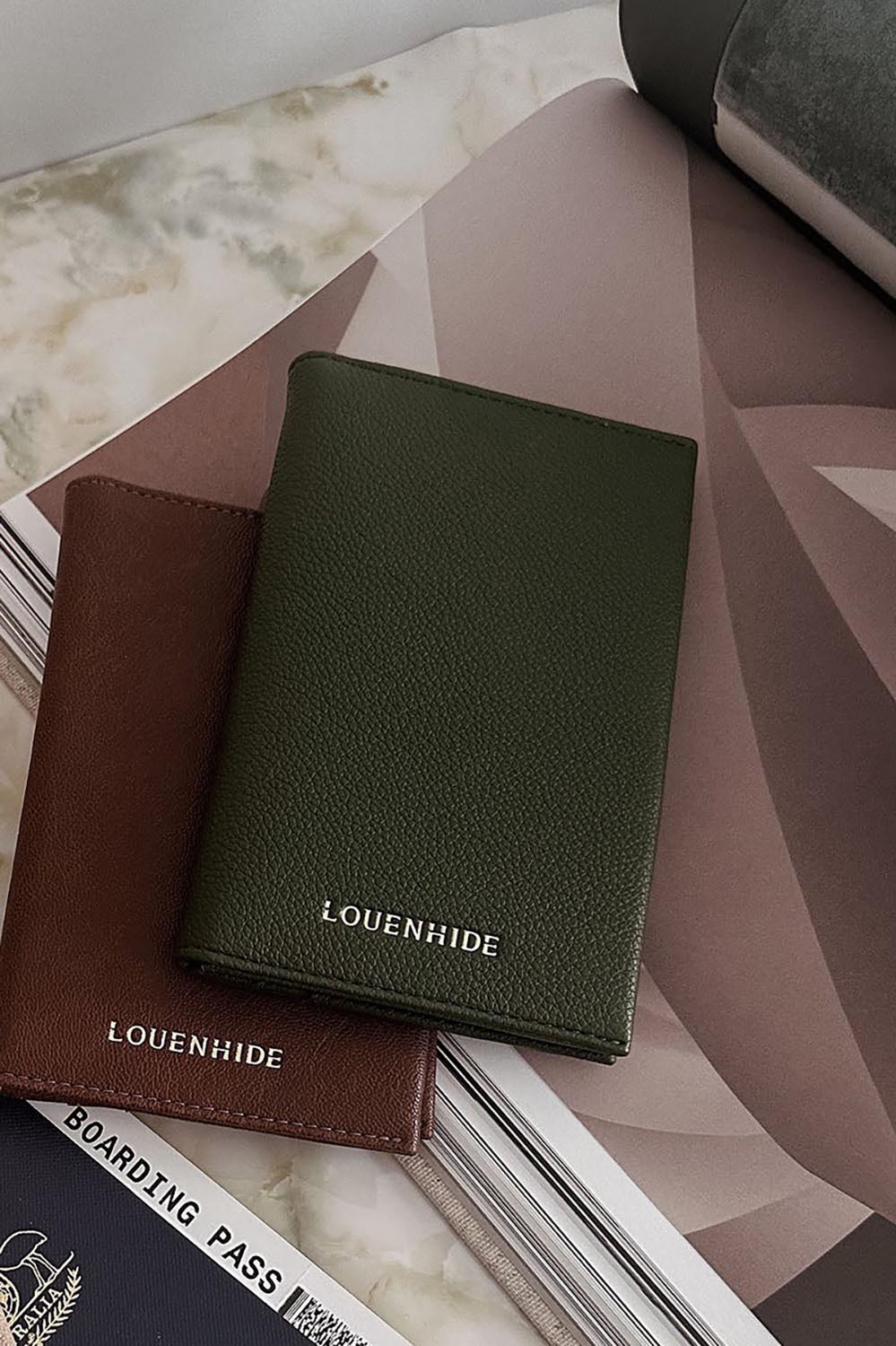 A model wearing the Venice Passport Wallet in colour Olive (Green), from the front, showing the whole outfit