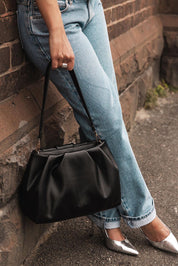 A model wearing the Naomi Convertible Clutch n Shoulder Bag in colour Black (Black), from the front, showing the whole outfit
