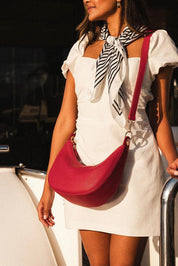 A model wearing the Corfu Handbag in colour Red (Red), from the front, showing the whole outfit