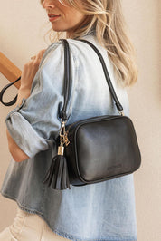 A model wearing the Jacinta Gia Crossbody Bag in colour Black (Black), from the front, showing the whole outfit