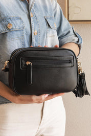 A model wearing the Jacinta Gia Crossbody Bag in colour Black (Black), from the front, showing the whole outfit