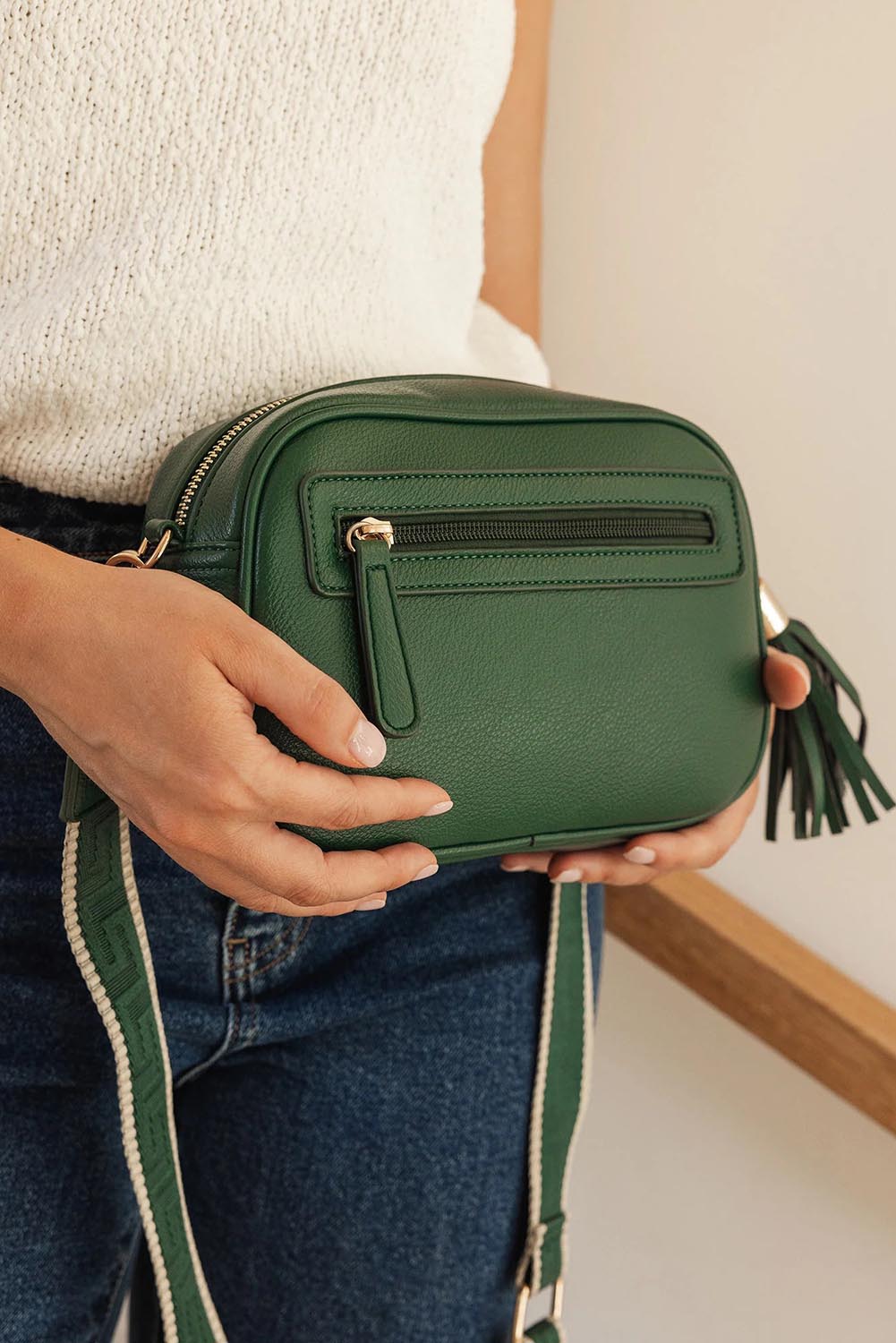 A model wearing the Jacinta Gia Crossbody Bag in colour Forestgrn (Green), from the front, showing the whole outfit