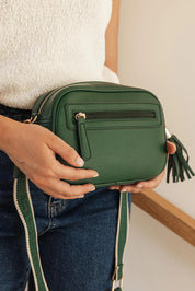 A model wearing the Jacinta Gia Crossbody Bag in colour Forestgrn (Green), from the front, showing the whole outfit