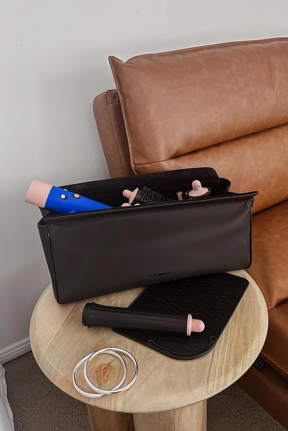 A model wearing the Margot Hot Tool Case in colour Black (Black), from the front, showing the whole outfit