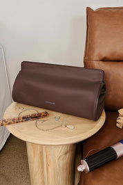 A model wearing the Margot Hot Tool Case in colour Chocolate, from the front, showing the whole outfit