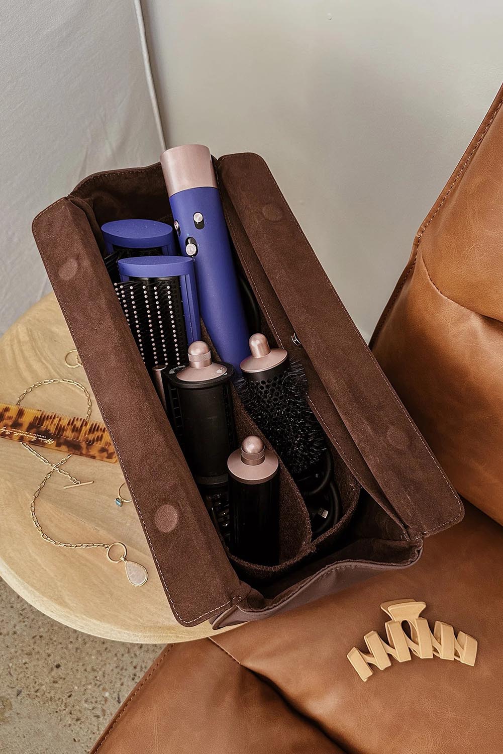 A model wearing the Margot Hot Tool Case in colour Chocolate, from the front, showing the whole outfit