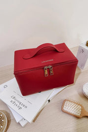 A model wearing the Orion Cosmetic Case in colour Red (Red), from the front, showing the whole outfit