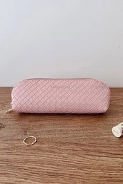 A model wearing the Jayne Makeup Bag in colour Duskypink (Pink), from the front, showing the whole outfit