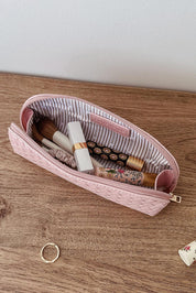 A model wearing the Jayne Makeup Bag in colour Duskypink (Pink), from the front, showing the whole outfit