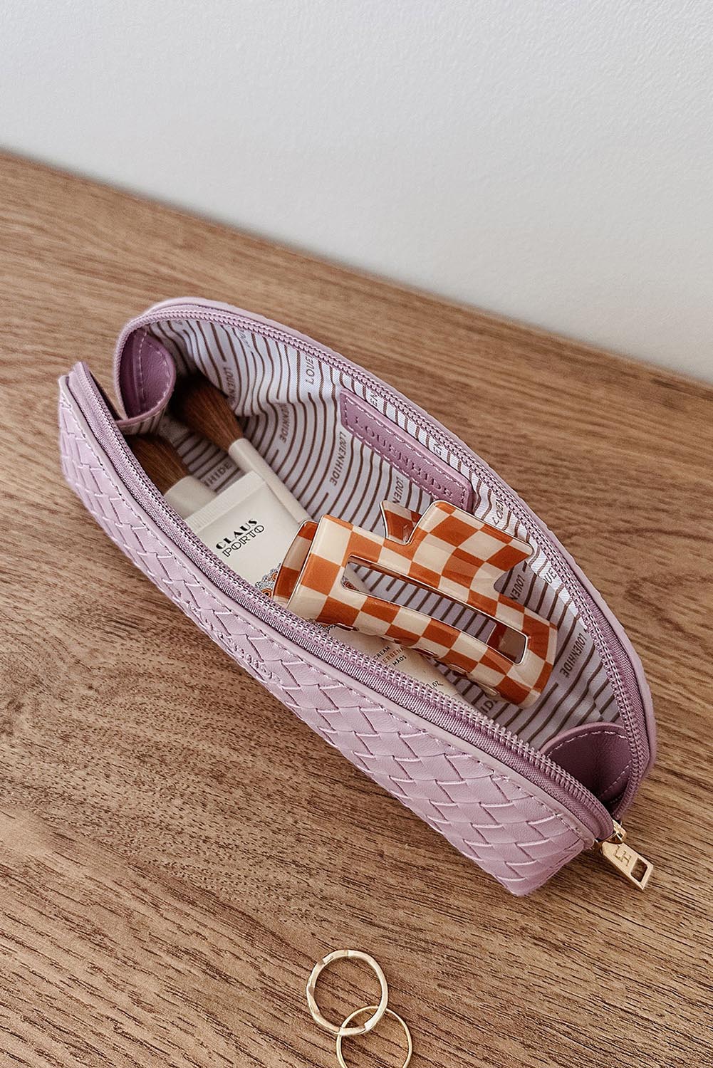 A model wearing the Jayne Makeup Bag in colour Lilac (Purple), from the front, showing the whole outfit