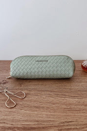 A model wearing the Jayne Makeup Bag in colour Sagegreen (Green), from the front, showing the whole outfit